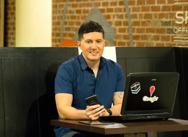 Ish Laos, founder of WebStuffGuy, at a laptop in Atlanta